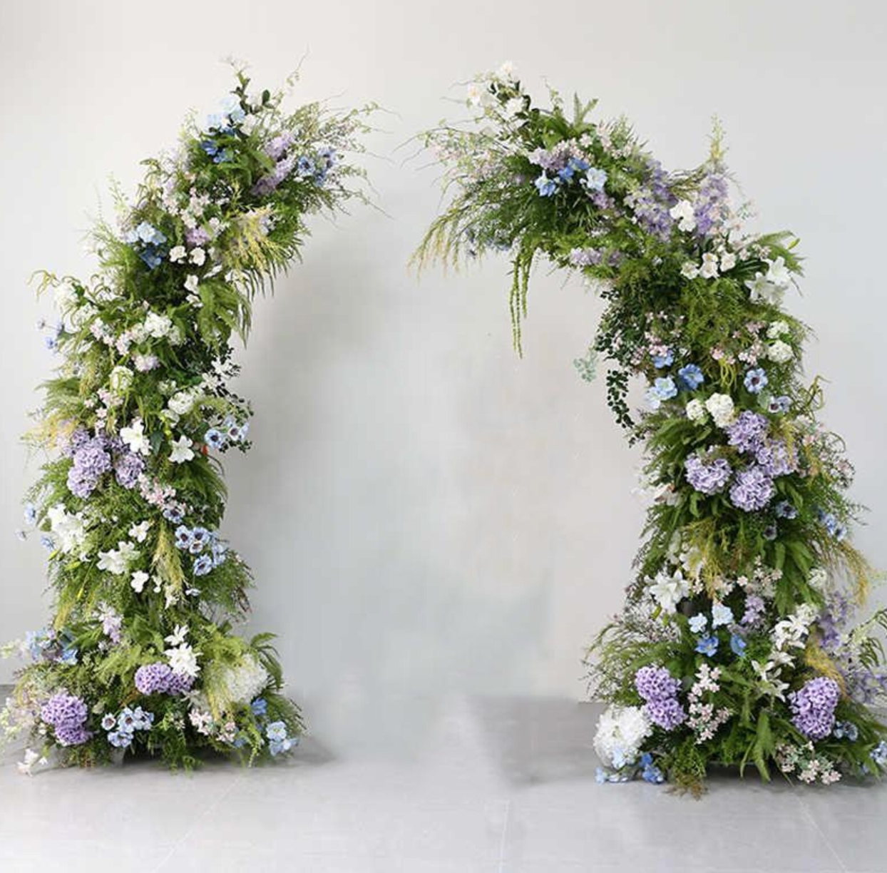 Arch with flowers in White, light blue, lilac, & green foliage