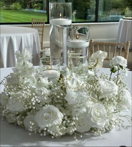Low wedding centerpiece with 3 cylinder and floating candles